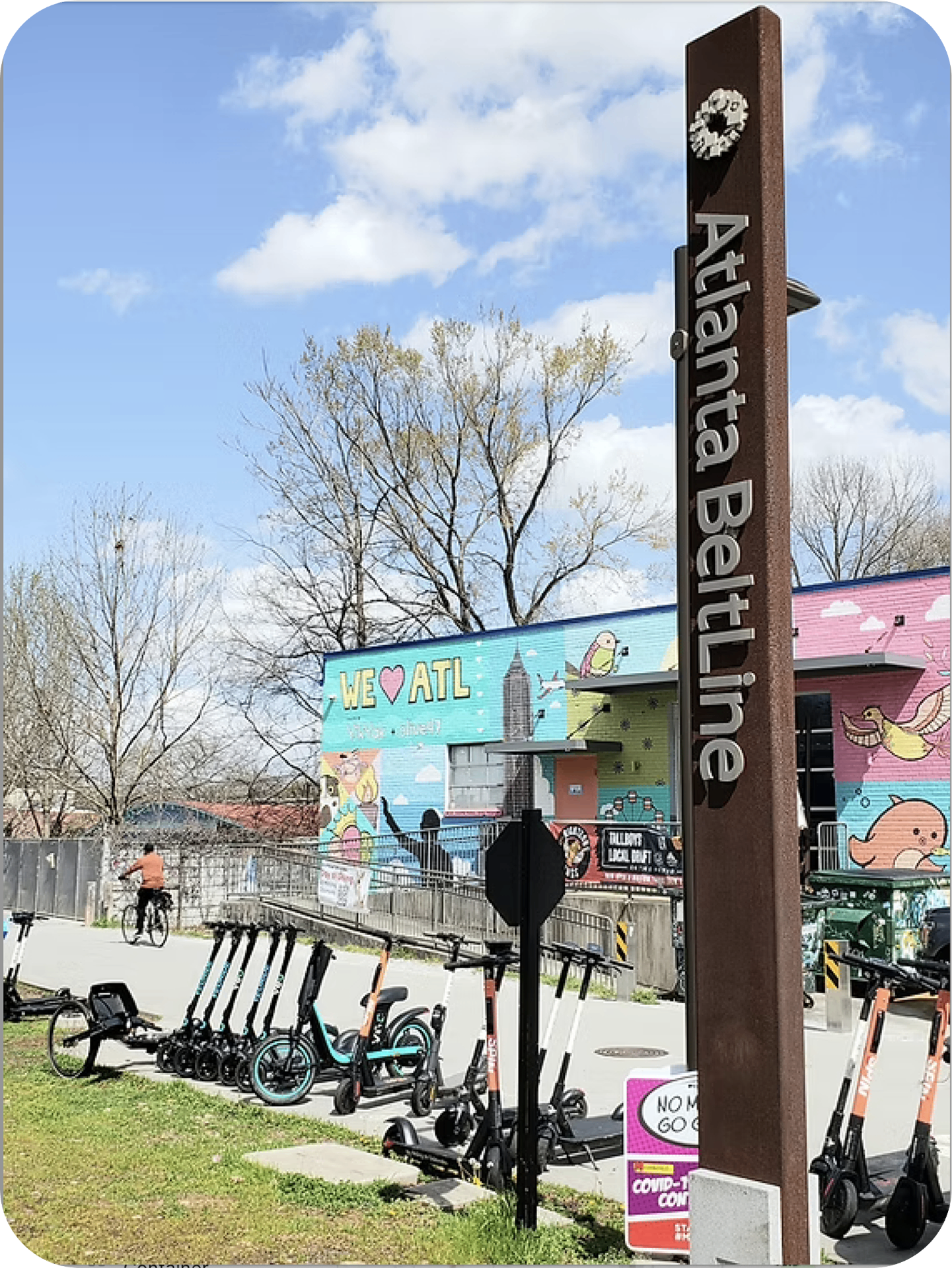 Atlanta BeltLine trail marker with scooters and murals
